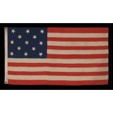 13 STARS IN A 3-2-3-2-3 LINEAL CONFIGURATION ON AN ANTIQUE AMERICAN FLAG MADE IN NEW YORK CITY BY JOHN BOYLE & COMPANY, CA 1885-1900, WITH AN UNUSUAL, BLACK-INKED STENCIL ALONG THE HOIST THAT READS “BOYLE’S YACHT SAIL”