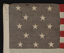 13 STARS IN A 3-2-3-2-3 PATTERN ON A SMALL-SCALE FLAG OF THE 1890's-1910 ERA; UNUSUAL BLUE CANTON WITH GOLD OVERTONES