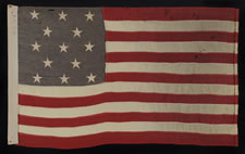 13 STARS IN A 3-2-3-2-3 PATTERN ON A SMALL-SCALE FLAG OF THE 1890's-1910 ERA; UNUSUAL BLUE CANTON WITH GOLD OVERTONES