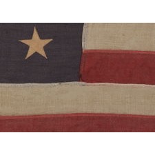 13 STARS IN A 3-2-3-2-3 PATTERN ON A DUSTY BLUE CANTON, ON A SMALL-SCALE, ANTIQUE AMERICAN FLAG WITH AN ELONGATED PROFILE, MADE DURING THE LAST DECADE OF THE 19TH CENTURY, CA 1890-1895