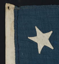 13 STARS IN A 4-5-4 CONFIGURATION, ENTIRELY HAND-SEWN, A U.S. NAVY SMALL BOAT ENSIGN WITH A SMALL CANTON AND AN ELONGATED FORMAT, MADE SOMETIME BETWEEN 1850 AND THE OPENING YEARS OF THE CIVIL WAR (1861-1863)