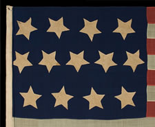 13 STARS IN A 4-5-4 CONFIGURATION, A U.S. NAVY SMALL BOAT ENSIGN, ENTIRELY HAND-SEWN, WITH UNUSUALLY LARGE STARS THAT HAVE AN UNCOMMONLY BOLD PRESENTATION, MADE SOMETIME BETWEEN 1850 AND THE OPENING YEARS OF THE CIVIL WAR (1861-63)