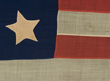 13 STARS IN A 4-5-4 CONFIGURATION, A U.S. NAVY SMALL BOAT ENSIGN, ENTIRELY HAND-SEWN, WITH UNUSUALLY LARGE STARS THAT HAVE AN UNCOMMONLY BOLD PRESENTATION, MADE SOMETIME BETWEEN 1850 AND THE OPENING YEARS OF THE CIVIL WAR (1861-63)