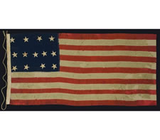 13 STARS IN A 4-5-4 CONFIGURATION, ENTIRELY HAND-SEWN, PROBABLY A U.S. NAVY SMALL BOAT ENSIGN IN A GREAT SIZE, WITH GREAT GRAPHIC QUALITIES, MADE SOMETIME BETWEEN 1850 AND THE OPENING YEARS OF THE CIVIL WAR (1861-1863)