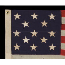 13 STARS ARRANGED IN A 3-2-3-2-3 LINEAL CONFIGURATION ON A SMALL-SCALE ANTIQUE AMERICAN FLAG MADE DURING THE FIRST HALF OF THE 1890's