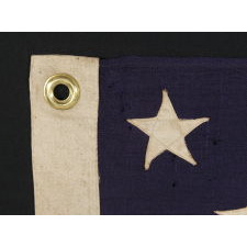 13 STARS ARRANGED IN A 3-2-3-2-3 LINEAL CONFIGURATION ON A SMALL-SCALE ANTIQUE AMERICAN FLAG MADE DURING THE FIRST HALF OF THE 1890's