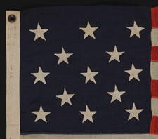 13 STARS ARRANGED IN A 3-2-3-2-3 PATTERN ON A SMALL-SCALE FLAG MADE IN THE 1895-1926 ERA