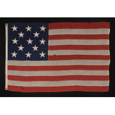 13 STARS ARRANGED IN A 3-2-3-2-3 PATTERN ON A SMALL-SCALE ANTIQUE AMERICAN FLAG MARKED "UNITED STATES ARMY STANDARD BUNTING", CA 1895 - 1910