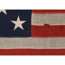 13 STARS ARRANGED IN A 3-2-3-2-3 PATTERN ON A SMALL-SCALE ANTIQUE AMERICAN FLAG MARKED "UNITED STATES ARMY STANDARD BUNTING", CA 1895 - 1910