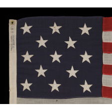 13 STARS ARRANGED IN A 3-2-3-2-3 PATTERN ON A SMALL-SCALE ANTIQUE AMERICAN FLAG MARKED "UNITED STATES ARMY STANDARD BUNTING", CA 1896 - 1908