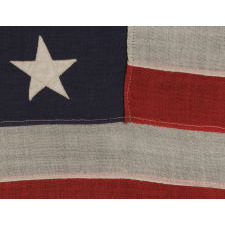 13 STARS ARRANGED IN A 3-2-3-2-3 PATTERN ON A SMALL-SCALE ANTIQUE AMERICAN FLAG MARKED "UNITED STATES ARMY STANDARD BUNTING", CA 1896 - 1908