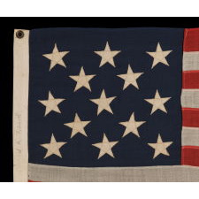 13 STARS ARRANGED IN A 3-2-3-2-3 PATTERN ON A SMALL-SCALE ANTIQUE AMERICAN FLAG MADE IN THE PERIOD BETWEEN THE LAST DECADE OF THE 19TH CENTURY AND THE FIRST QUARTER OF THE 20TH