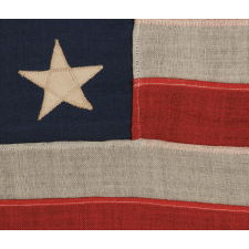 13 STARS ARRANGED IN A 3-2-3-2-3 PATTERN ON A SMALL-SCALE ANTIQUE AMERICAN FLAG MADE IN THE PERIOD BETWEEN THE LAST DECADE OF THE 19TH CENTURY AND THE FIRST QUARTER OF THE 20TH