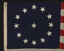 13 STARS IN A CIRCULAR VERSION OF THE 3RD MARYLAND PATTERN, ON A SMALL-SCALE FLAG MADE IN THE 1890-1920's ERA