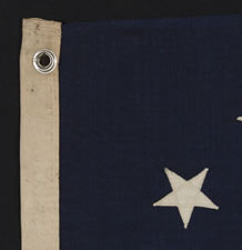 13 STARS IN A CIRCULAR VERSION OF THE 3RD MARYLAND PATTERN, ON A SMALL-SCALE FLAG MADE IN THE 1890-1920's ERA