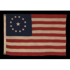 13 STARS IN A CIRCULAR VERSION OF THE 3RD MARYLAND PATTERN, ON AN ESPECIALLY ATTRACTIVE, SMALL SCALE, ANTIQUE AMERICAN FLAG, MADE IN THE 1890-1910 ERA