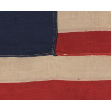 13 STARS IN A CIRCULAR VERSION OF THE 3RD MARYLAND PATTERN, ON AN ESPECIALLY ATTRACTIVE, SMALL SCALE, ANTIQUE AMERICAN FLAG, MADE IN THE 1890-1910 ERA