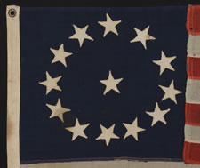 13 STARS IN A CIRCULAR VERSION OF THE 3RD MARYLAND PATTERN, ON A SMALL-SCALE FLAG MADE IN THE 1895-1920's ERA