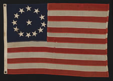 13 STARS IN A CIRCULAR VERSION OF THE 3RD MARYLAND PATTERN, ON A SMALL-SCALE FLAG MADE IN THE 1895-1920's ERA