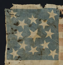 13 STARS, A COTTON PARADE FLAG, MADE IN THE PERIOD BETWEEN 1850 AND THE CIVIL WAR, LIKELY TAKEN FROM THE BODY OF A UNION SOLDIER BY JOHN S. WHITE OF THE 21ST MISSOURI VOLUNTEERS, COMPANY H