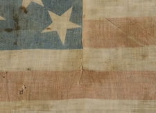 13 STARS, A COTTON PARADE FLAG, MADE IN THE PERIOD BETWEEN 1850 AND THE CIVIL WAR, LIKELY TAKEN FROM THE BODY OF A UNION SOLDIER BY JOHN S. WHITE OF THE 21ST MISSOURI VOLUNTEERS, COMPANY H