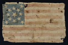 13 STARS, A COTTON PARADE FLAG, MADE IN THE PERIOD BETWEEN 1850 AND THE CIVIL WAR, LIKELY TAKEN FROM THE BODY OF A UNION SOLDIER BY JOHN S. WHITE OF THE 21ST MISSOURI VOLUNTEERS, COMPANY H