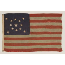 13 STARS IN A MEDALLION CONFIGURATION ON A SMALL-SCALE ANTIQUE AMERICAN FLAG OF THE 1890-1900 ERA, WITH AMPLE WEAR AND LOSSES