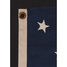 13 STARS IN A MEDALLION CONFIGURATION ON A SMALL-SCALE ANTIQUE AMERICAN FLAG OF THE 1890-1900 ERA