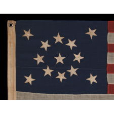 13 STARS IN A MEDALLION CONFIGURATION ON A SMALL-SCALE ANTIQUE AMERICAN FLAG OF THE 1895-1926 ERA, SIGNED "TAUTOG," PROBABLY FLOWN ON THE YACHT OF THAT NAME BY OWNER GEORGE GARDINER FRY, WHO WON MANY RACES WITH HER AT THE TURN-OF-THE-CENTURY