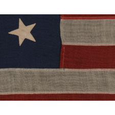 13 STARS IN A MEDALLION CONFIGURATION ON A SMALL-SCALE ANTIQUE AMERICAN FLAG OF THE 1895-1926 ERA, SIGNED "TAUTOG," PROBABLY FLOWN ON THE YACHT OF THAT NAME BY OWNER GEORGE GARDINER FRY, WHO WON MANY RACES WITH HER AT THE TURN-OF-THE-CENTURY