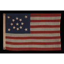 13 STARS IN A MEDALLION CONFIGURATION ON A SMALL-SCALE ANTIQUE AMERICAN FLAG OF THE 1895-1926 ERA, SIGNED "TAUTOG," PROBABLY FLOWN ON THE YACHT OF THAT NAME BY OWNER GEORGE GARDINER FRY, WHO WON MANY RACES WITH HER AT THE TURN-OF-THE-CENTURY