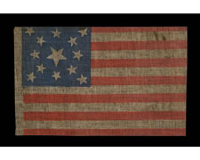 13 STARS, MEDALLION PATTERN, MADE SOMETIME BETWEEN THE CIVIL WAR (1861-65) AND THE 1876 CENTENNIAL OF OUR NATION'S INDEPENDENCE, AN UNUSUAL EXAMPLE WITH ESPECIALLY ATTRACTIVE STARS AND AN UPSIDE-DOWN CENTER STAR