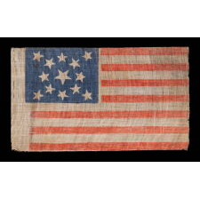 13 STARS IN A MEDALLION PATTERN ON AN ANTIQUE AMERICAN PARADE FLAG MADE SOMETIME BETWEEN THE CIVIL WAR (1861-1865) AND THE 1876 CENTENNIAL OF AMERICAN INDEPENDENCE, WITH A BEAUTIFUL, CORNFLOWER BLUE CANTON AND IN AN UNUSUALLY LARGE SIZE AMONG ITS COUNTERPARTS