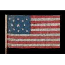 13 STARS IN A MEDALLION PATTERN ON AN ANTIQUE AMERICAN PARADE FLAG MADE FOR THE 1876 CENTENNIAL CELEBRATION