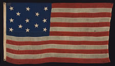 13 STARS WITH SCATTERED POSITIONING IN A 3-2-3-2-3 CONFIGURATION, MADE EITHER FOR THE 1876 CENTENNIAL CELEBRATION OR AS A PRIVATE NAUTICAL ENSIGN, CA 1876-1895