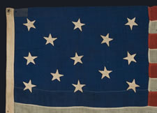 13 STARS WITH SCATTERED POSITIONING IN A 3-2-3-2-3 CONFIGURATION, MADE EITHER FOR THE 1876 CENTENNIAL CELEBRATION OR AS A PRIVATE NAUTICAL ENSIGN, CA 1876-1895