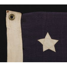 13 STARS WITH SHORT, CONICAL ARMS, ARRANGED IN A MEDALLION CONFIGURATION ON A SMALL SCALE FLAG MADE DURING THE LAST DECADE OF THE 19TH CENTURY, POSSIBLY OF PHILADELPHIA ORIGIN