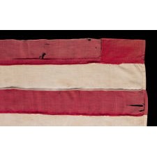 20 STARS AND 11 STRIPES ON AN ANTIQUE AMERICAN FLAG OF THE CIVIL WAR PERIOD, HOMEMADE AND ENTIRELY-HAND-SEWN, WITH ITS LIGHT BLUE CANTON RESTING ON THE WAR STRIPE; PROBABLY MADE TO COMMEMORATE THE DECEMBER 10TH, 1817 ADDITION OF MISSISSIPPI AS THE 20TH STATE, AND THE COUNT OF 11 STATES THAT SECEDED FROM THE UNION BETWEEN DECEMBER OF 1860 AND JUNE OF 1861