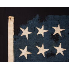 24 STAR ANTIQUE AMERICAN FLAG, MADE IN THE PERIOD WHEN MISSOURI WAS THE MOST RECENT STATE TO JOIN THE UNION, 1821-1836, EXTRAORDINARILY RARE, WITH ITS CANTON RESTING ON THE “WAR STRIPE” OR “BLOOD STRIPE," AND IN A REMARKABLY TINY SCALE AMONG FLAGS OF THIS ERA