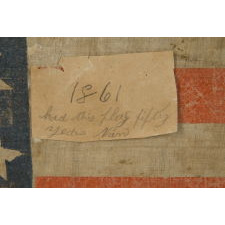 25 STARS IN A VERY RARE LINEAL ARRANGEMENT THAT FEATURES A LARGE CENTER STAR, SOUTHERN-EXCLUSIONARY, THE ONLY KNOWN EXAMPLE IN THIS STYLE AND THE ONLY 19TH CENTURY PARADE FLAG IN THIS STAR COUNT