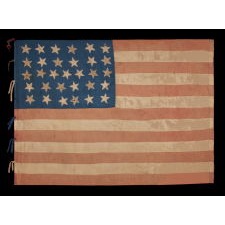 31 STARS IN A 6-6-7-6-6 LINEAL PATTERN, WITH SCATTERED ORIENTATION, ON AN ANTIQUE AMERICAN FLAG MADE OF SILK AND WITH THE BLUE CANTON RESTING ON THE WAR STRIPE, CALIFORNIA STATEHOOD, 1850-1858, LIKELY HAND-CARRIED INTO THE CIVIL WAR BY A MILITIA UNIT