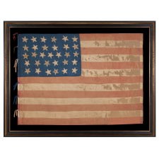 31 STARS IN A 6-6-7-6-6 LINEAL PATTERN, WITH SCATTERED ORIENTATION, ON AN ANTIQUE AMERICAN FLAG MADE OF SILK AND WITH THE BLUE CANTON RESTING ON THE WAR STRIPE, CALIFORNIA STATEHOOD, 1850-1858, LIKELY HAND-CARRIED INTO THE CIVIL WAR BY A MILITIA UNIT