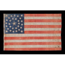 31 STARS ON AN ANTIQUE AMERICAN FLAG WITH ITS STARS CONFIGURED IN A MEDALLION PATTERN THAT FEATURES A LARGE, HALOED CENTER STAR; REFLECTS THE PERIOD WHEN CALIFORNIA HAD RECENTLY BECOME THE 31ST STATE TO ENTER THE UNION, 1850-1858