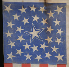 31 STARS IN A MEDALLION CONFIGURATION WITH A LARGE HALOED CENTER STAR, ON A CORNFLOWER BLUE CANTON, WITH AND TOMATO RED STRIPES, CALIFORNIA STATEHOOD, PRE-CIVIL WAR (1850-1858)