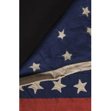 32 STARS ON AN ANTIQUE AMERICAN FLAG WITH ITS CANTON RESTING ON THE WAR STRIPE, MADE IN THE PERIOD WHEN MINNESOTA JOINED THE UNION AS THE 32nd STATE; A VERY RARE STAR COUNT, OFFICIAL FOR JUST ONE YEAR, AND ACCURATE FOR JUST NINE MONTHS, 1858-59