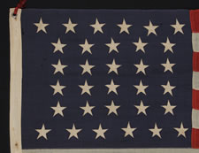 32 STARS, COMMEMORATING MINNESOTA STATEHOOD, CA 1892 - 1926, A VERY RARE FLAG, IN A SMALL SIZE, WITH AN HOURGLASS CONFIGURATION