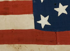 32 STARS, AN ESPECIALLY RARE, PRE-CIVIL WAR STAR COUNT, ON A RARE, SMALL SCALE, HOMEMADE FLAG, WITH ITS CANTON RESTING ON THE WAR STRIPE, 1858-59, MINNESOTA STATEHOOD