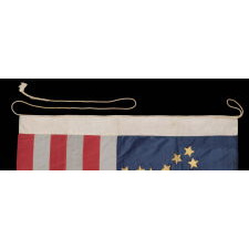 34 GILT PAINTED STARS IN A BOLD REPRESENTATION OF THE “GREAT STAR” PATTERN, ON A SILK, ANTIQUE AMERICAN FLAG MADE DURING THE OPENING YEARS OF THE CIVIL WAR, 1861-63, PROBABLY MADE UNDER MILITARY CONTRACT OR FOR USE BY LOCAL MILITIA, ENTIRELY HAND-SEWN, IN A TINY SCALE FOR THE PERIOD