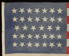 34 STAR, CIVIL WAR PERIOD (1861-63), A PRESS-DYED, MERINO WOOL FLAG WITH A HAND-SEWN COTTON HOIST AND GREAT, DUSTY BLUE COLORATION