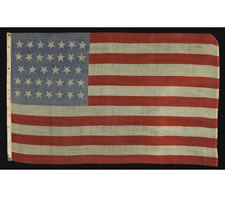 34 STAR, CIVIL WAR PERIOD (1861-63), A PRESS-DYED,  MERINO WOOL FLAG WITH A HAND-SEWN COTTON HOIST AND GREAT, DUSTY BLUE COLORATION